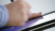 male hands using a stylus pen on tablet computer