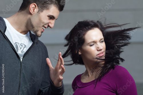 Photo: Young woman gets slapped by her boyfriend.Action shot Young woman gets slapped by her boyfriend.Action shot