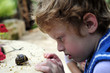 Boy considering the snail