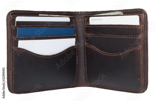 Photo: A brown leather wallet with cash and cards. A brown leather wallet with cash and cards.