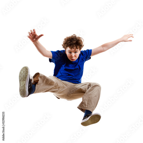 Photo: Boy jumping, running isolated on white background Boy jumping, running isolated on white background