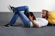young azh read a magazine on the floor