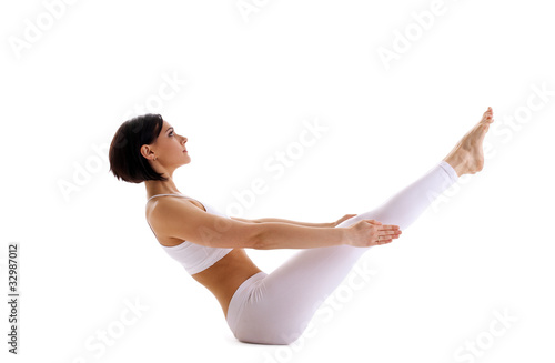 Photo: Young woman training yoga - fish pose isolated Young woman training yoga - fish pose isolated