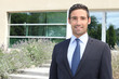 Businessman standing outside a modern house
