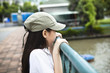 Photo: little girl standing on bridge watching river little girl standing on bridge watching river