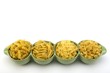 Assorted raw pasta noodles in green ceramic dish