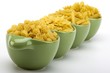 Assorted raw pasta noodles in green ceramic dish