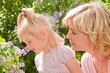 Photo: Little girl with mother sniffing lilacs Little girl with mother sniffing lilacs