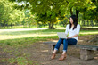 beautiful asian woman using laptop in the park