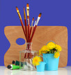 brushes with the palette and dandelions