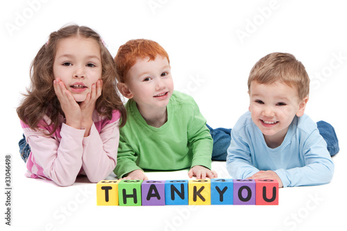 Photo: Three happy children with thankyou kids letter blocks Three happy children with thankyou kids letter blocks