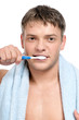 Young man brushing teeth