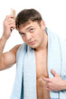 Young man combing his hair