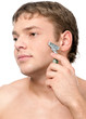 Portrait of a young handsome man shaving