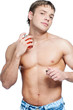 Cosmetic wellness man spraying fragrance