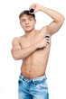 Muscular man's using an antiperspirant