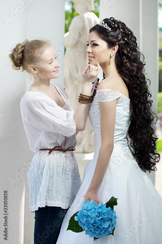 Photo: Stylist takes care of the bride Stylist takes care of the bride