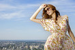 beautiful girl in sunglasses on background blue sky
