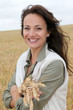 Beautiful woman standing in wheat field