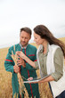 Agronomist with farmer looking at wheat ears