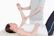 Sportswoman having her arm stretched by a masseuse