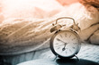 clock and bed showing wake time in bedroom