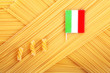 uncooked spaghetti close-up with an Italian flag