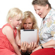 Photo: Three generations having fun with touchpad Three generations having fun with touchpad