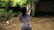 Two boys playing badminton in tropical surrounding