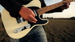 Close up of male playing solo on electronic guitar