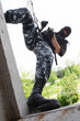 Soldier in mask on rope targeting through the window