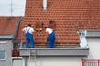 Two men working on the roof