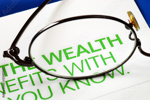 Photo: Focus on growth in wealth isolated on blue Focus on growth in wealth isolated on blue
