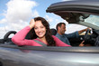Couple riding convertible car