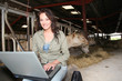 Veterinarian in barn with laptop computer Veterinarian in barn with laptop computer