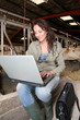 Veterinarian in barn with laptop computer Veterinarian in barn with laptop computer