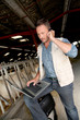 Breeder in barn with laptop computer Breeder in barn with laptop computer