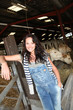 Smiling woman farmer standing in barn