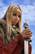 Viking girl warrior on a blue sky background