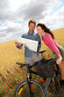 Couple riding looking at map on bike ride