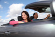 Couple riding convertible car