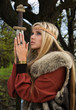 Viking girl  with sword in a wood