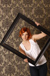 Attractive red head with picture frame