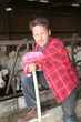 Portrait of smiling farmer in barn Portrait of smiling farmer in barn