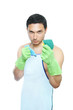 Cleaning man in apron holding cleaning sponge and duster