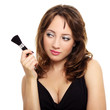 Photo: An attractive young lady with makeup brush An attractive young lady with makeup brush