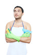 man in apron with cleaning sponge and duster looking up