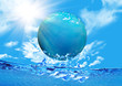 Breadboard model of globe floating on water against the sky