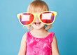 A little girl with a huge sunglasses