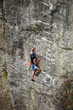 Photo: Rock climber on cliff battling his way up Rock climber on cliff battling his way up